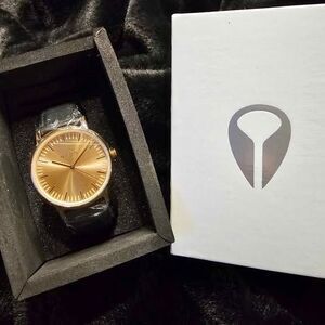 New in box, Nixon rose gold watch with leather band.
